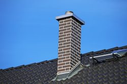 Chimney,Clad,With,Clinker,Bricks,On,A,Newly,Covered,Roof