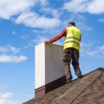 Professional,Workman,Standing,Roof,Top,And,Measuring,Chimney,Of,New