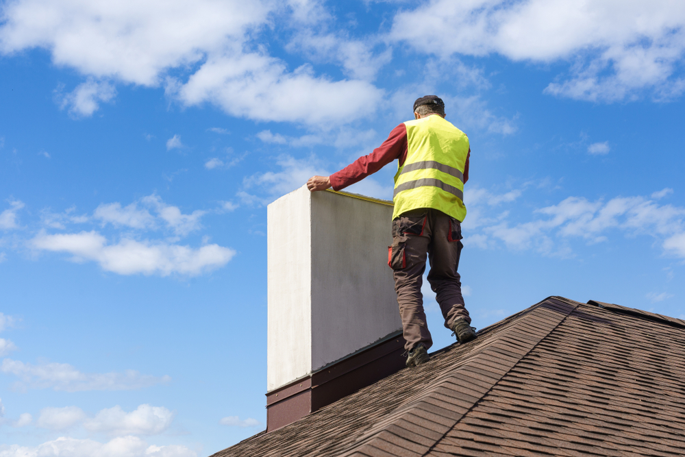 Professional,Workman,Standing,Roof,Top,And,Measuring,Chimney,Of,New