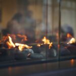 Modern,Gas,Fireplace,With,Dancing,Flames,Over,Pebbles,,Reflecting,A